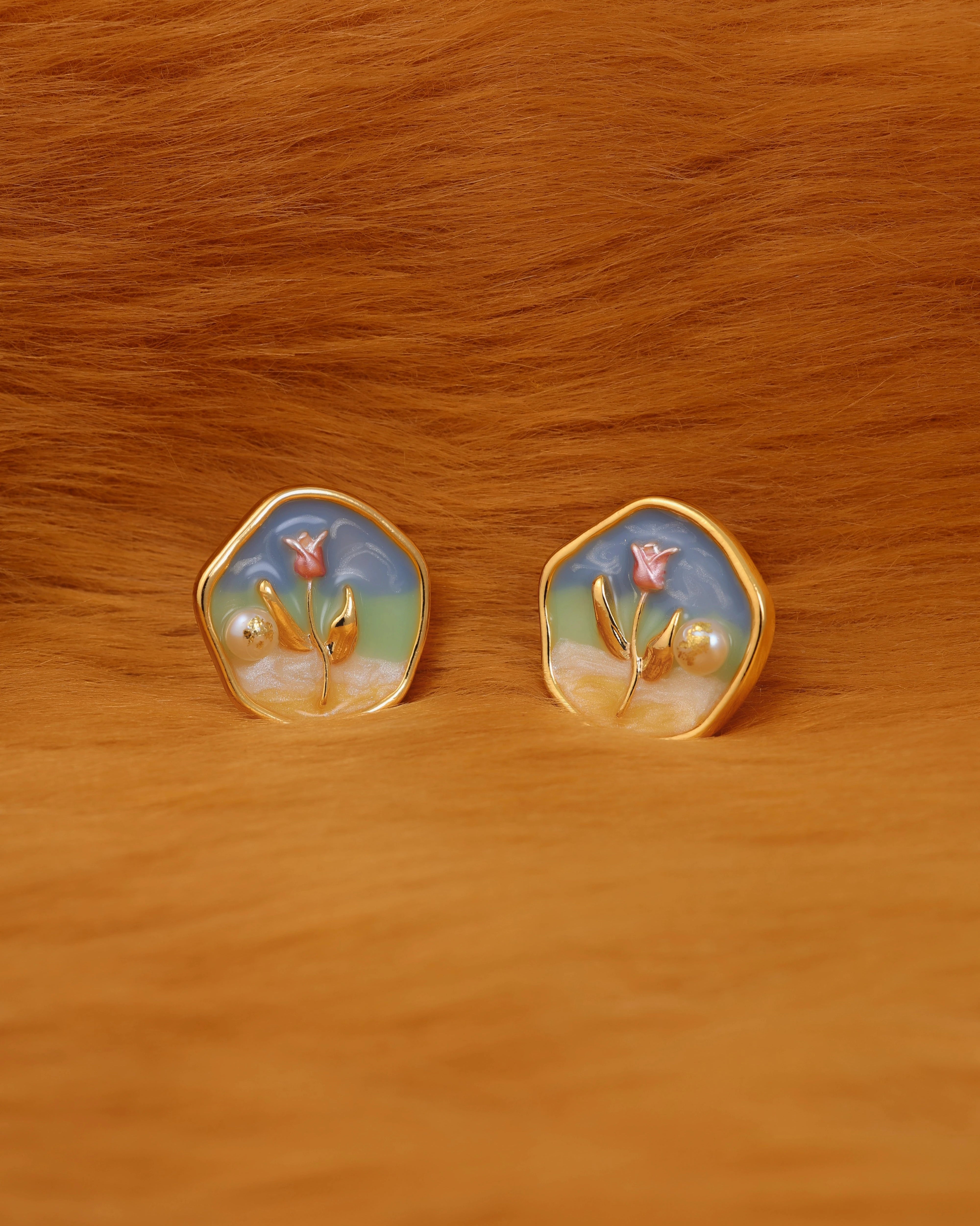 Pair of earrings with floral design on a fur surface