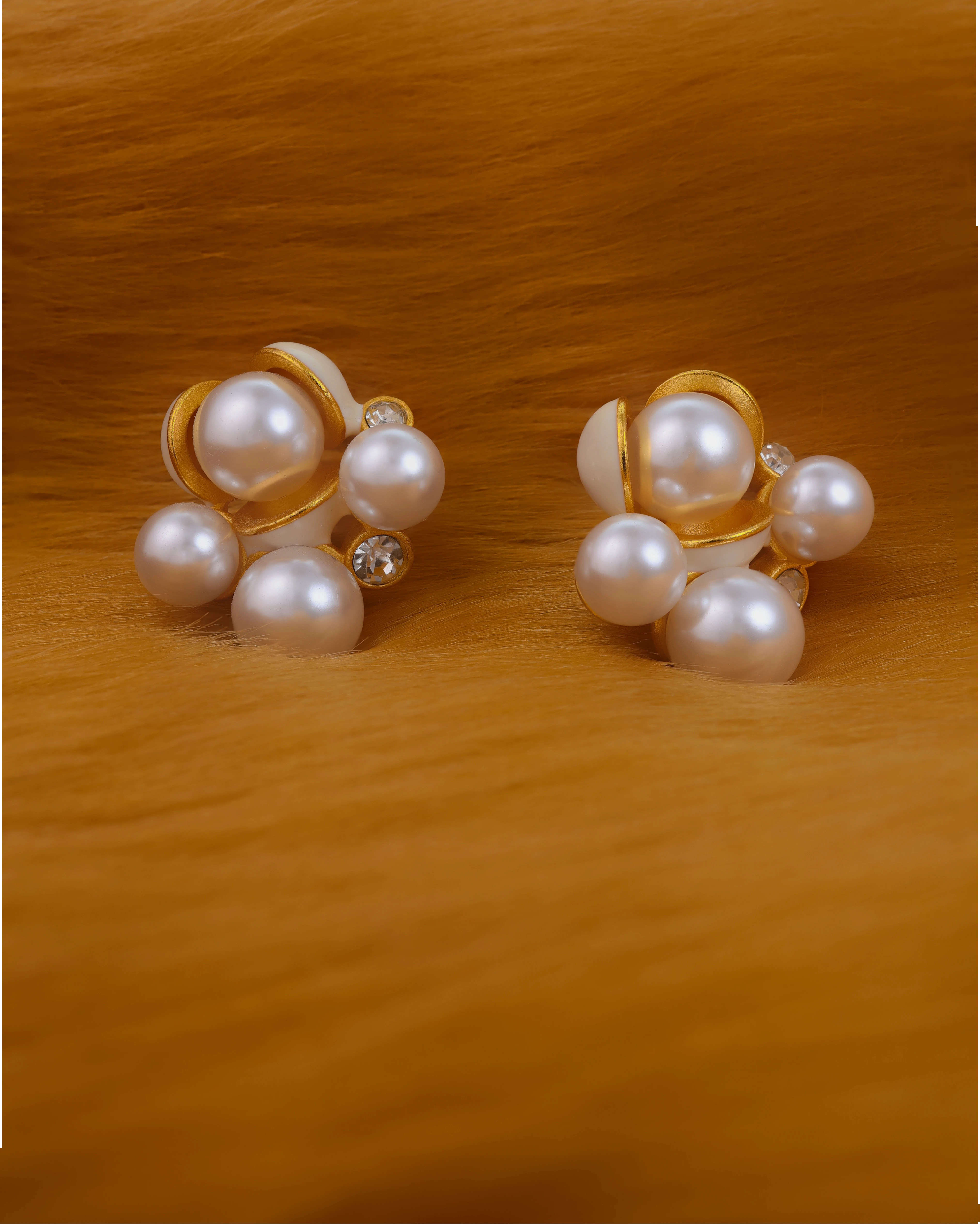 Pair of pearl earrings on a fur