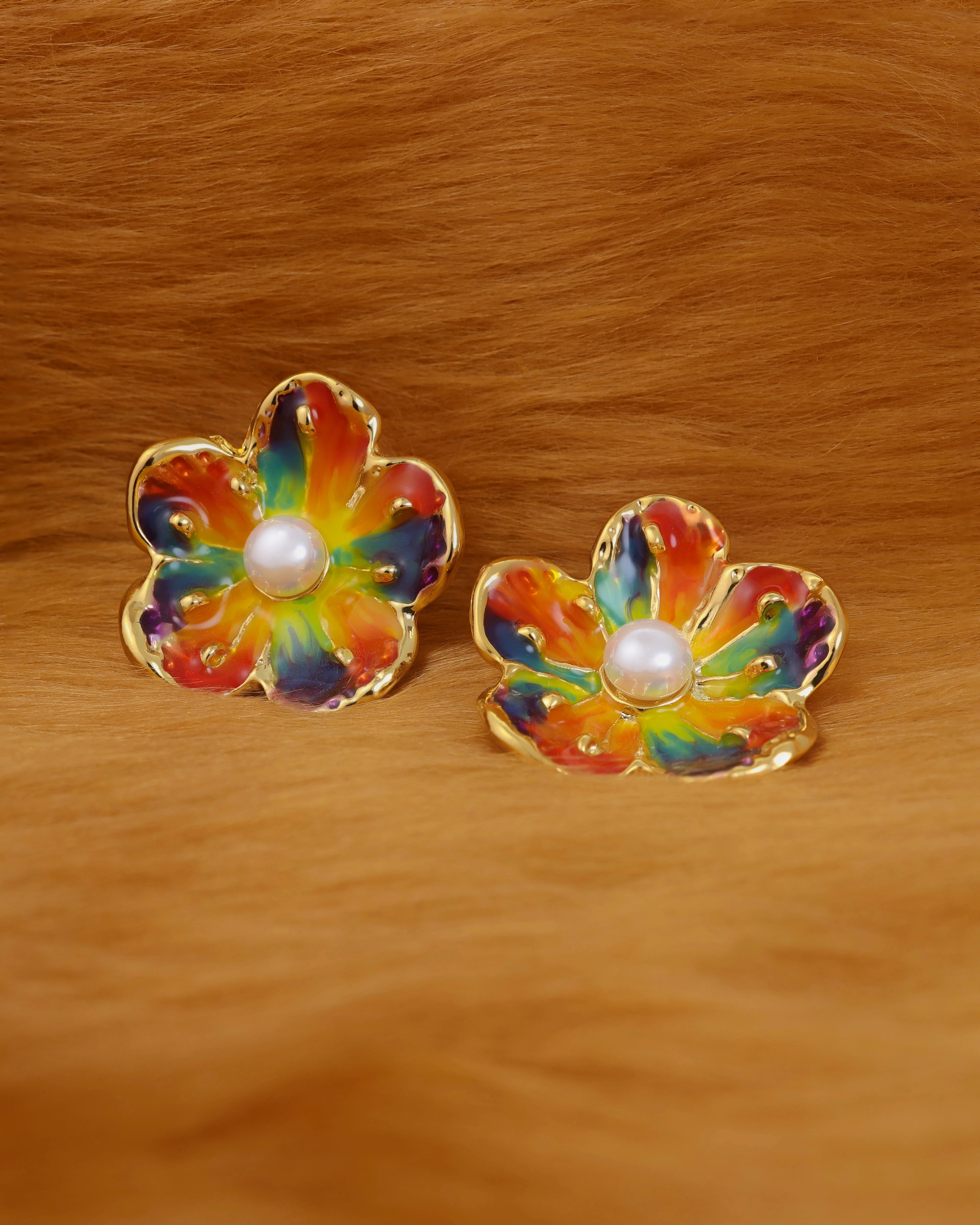 Pair of colorful flower-shaped earrings with a pearl center on fur